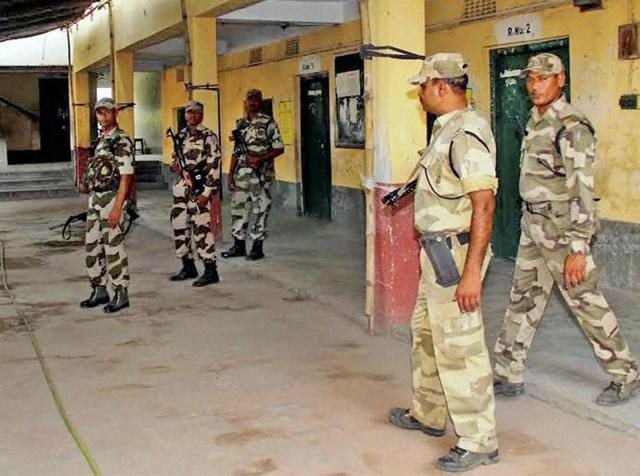 Central paramilitary personnel stand guard outside a polling booth on the eve of the third phase of polling in Burdwan on Wednesday. (PTI photo) Central paramilitary personnel stand guard outside a polling booth on the eve of the third phase of polling in Burdwan on Wednesday. (PTI photo)