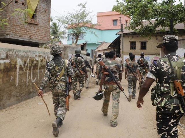 Central Force jawans stand guard inside a polling booth on the eve of 3rd phase of Assembly Polls in Burdwan district of West Bengal on Wednesday. (PTI Photo)