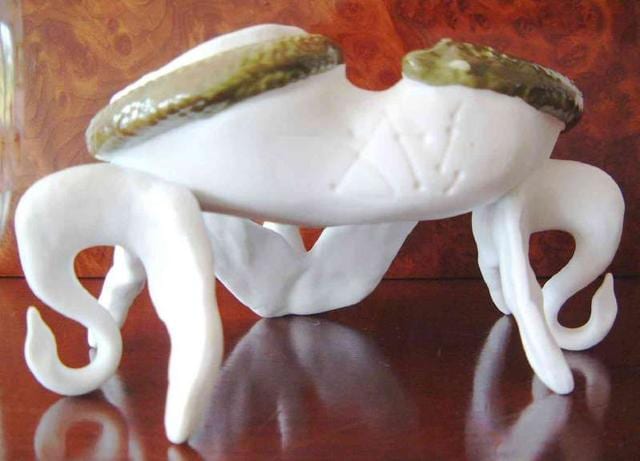 The ashtray is mostly unglazed porcelain with a glazed serpent around the lip of the ashtray. (Source: columbia.edu) The ashtray is mostly unglazed porcelain with a glazed serpent around the lip of the ashtray. (Source: columbia.edu)