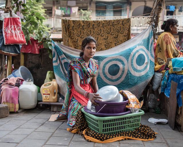 Anita lives in the compound of a residential complex and has taken up the responsibility of getting her niece educated. Anita Kharva, 21, has lived her entire life on a footpath near Mumbai Central station. She earns daily income from buying and selling old clothes. (BIND Collective) Anita lives in the compound of a residential complex and has taken up the responsibility of getting her niece educated. Anita Kharva, 21, has lived her entire life on a footpath near Mumbai Central station. She earns daily income from buying and selling old clothes. (BIND Collective)