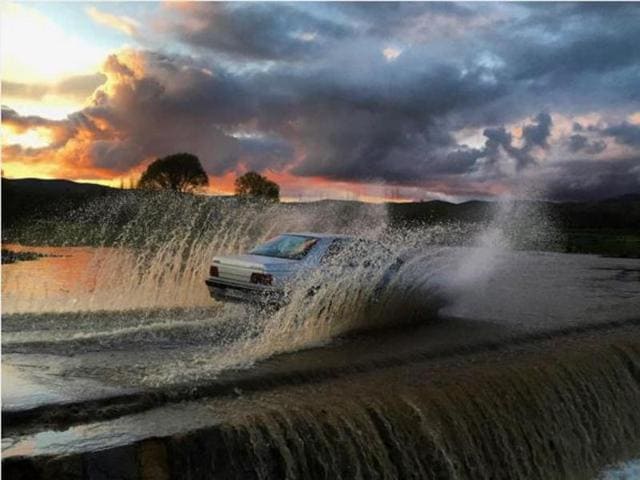 A car splashed through water in Iran.