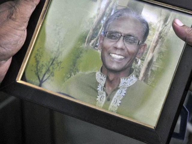 A man holds a portrait of Bangladeshi professor Rezaul Karim Siddique, who was hacked to death in Rajshahi. (AFP) A man holds a portrait of Bangladeshi professor Rezaul Karim Siddique, who was hacked to death in Rajshahi. (AFP)