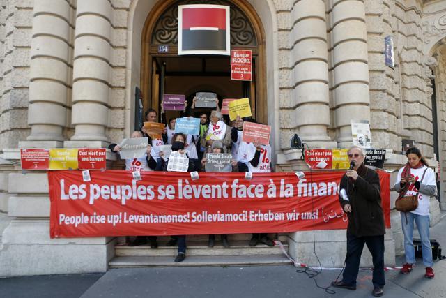Dominique Plihot, spokesperson for ATTAC, right, speaks with anti-fraud activists blocking entrances at Societe Generale's Paris headquarters as part of a protest accusing the French bank of ties to the so-called "Panama Papers", in Paris on April 7. (AP) Dominique Plihot, spokesperson for ATTAC, right, speaks with anti-fraud activists blocking entrances at Societe Generale's Paris headquarters as part of a protest accusing the French bank of ties to the so-called "Panama Papers", in Paris on April 7. (AP)