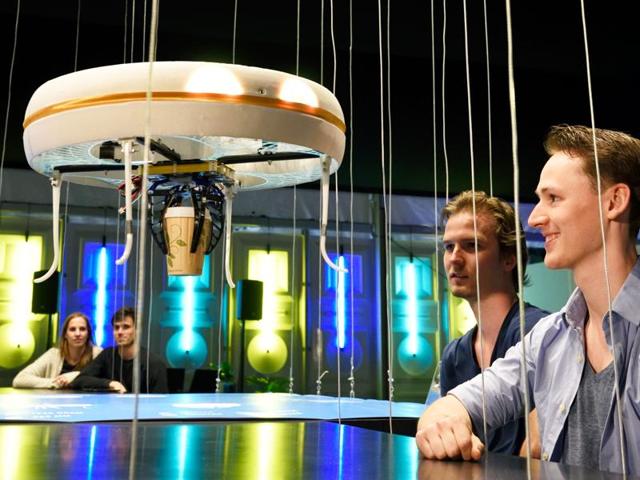 A flying drone bringing drinks to customers in the world's first drone cafe in Eindhoven. (AFP) A flying drone bringing drinks to customers in the world's first drone cafe in Eindhoven. (AFP)