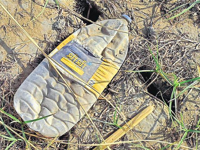 Construction debris and plastic waste, including Sri Sri brand water bottles, dotted the floodplain on Saturday.(Saumya Khandelwal/ HT Photo) Construction debris and plastic waste, including Sri Sri brand water bottles, dotted the floodplain on Saturday.(Saumya Khandelwal/ HT Photo)