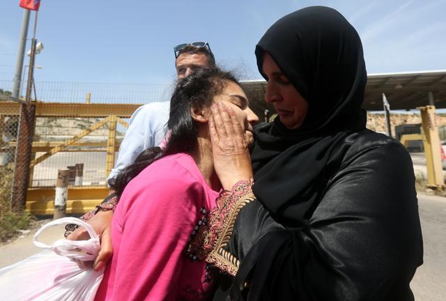 The mother (R) of Palestinian Dima al Wawi, 12, reacts after her release from Israeli prison. (AFP Photo) The mother (R) of Palestinian Dima al Wawi, 12, reacts after her release from Israeli prison. (AFP Photo)