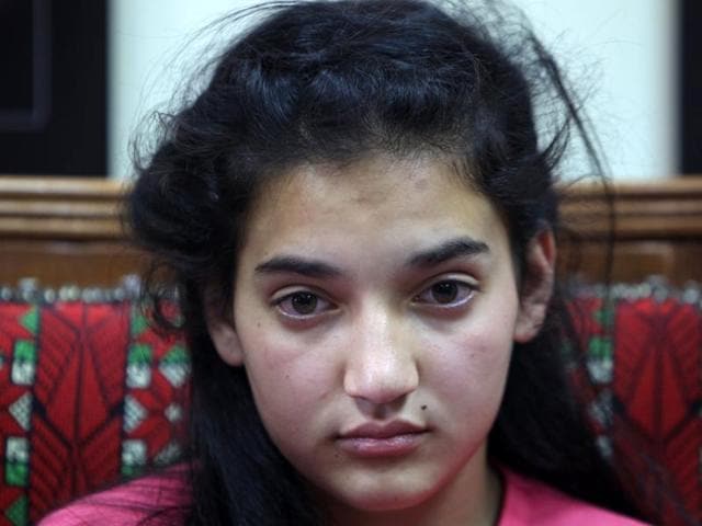 Palestinian Dima al Wawi, 12, who is believed to be the youngest female detained by Israel, looks on as she sits inside her house in the West Bank city of Tulkarem. (AFP Photo) Palestinian Dima al Wawi, 12, who is believed to be the youngest female detained by Israel, looks on as she sits inside her house in the West Bank city of Tulkarem. (AFP Photo)