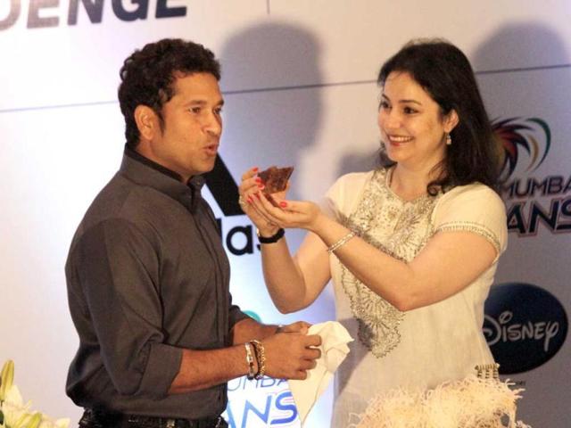 Anjali Tendulkar, wife of Sachin Tendulkar, offers him a piece of cake during his 40th birthday celebrations in Kolkata, India. (AP Photo)