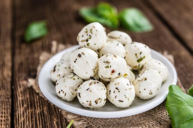 Fresh Mozzarella cheese in herbs. (Shutterstock)