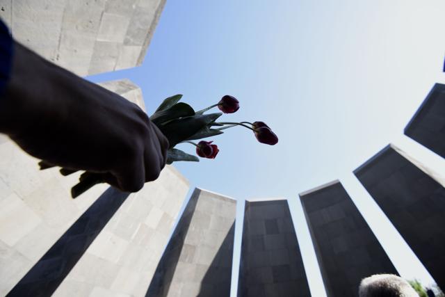 A picture taken in Yerevan at the Armenian Genocide Memorial shows flowers in a hand during a ceremony to commemorate the 101st anniversary of the World War I-era Armenian genocide in the Ottoman Empire. Hollywood star and rights advocate George Clooney led thousands of Armenians on a march to a hilltop memorial in Yerevan to commemorate the anniversary. (AFP) A picture taken in Yerevan at the Armenian Genocide Memorial shows flowers in a hand during a ceremony to commemorate the 101st anniversary of the World War I-era Armenian genocide in the Ottoman Empire. Hollywood star and rights advocate George Clooney led thousands of Armenians on a march to a hilltop memorial in Yerevan to commemorate the anniversary. (AFP)