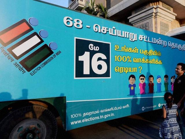 A family looks at a decorated bus which spreads awareness about the importance of voting, ahead of the Tamil Nadu assembly elections, in Chennai. (PTI Photo) A family looks at a decorated bus which spreads awareness about the importance of voting, ahead of the Tamil Nadu assembly elections, in Chennai. (PTI Photo)
