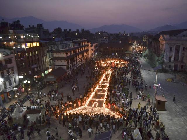 Kathmandu residents lit candles to create the shape of historic nine-storey Dharara tower and Kasthamandap temple to mark the first anniversary of the devastating earthquake that ripped through the Himalayan nation and killed thousands of people. (Raj K Raj/Hindustan Times) 