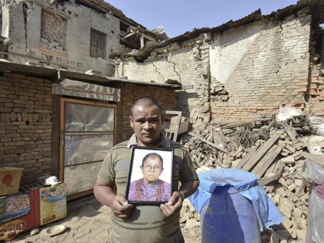Rajendra Dankiya shows a photo of his mother who died in the devastating quake in 2015.  (Raj K Raj/Hindustan Times) 