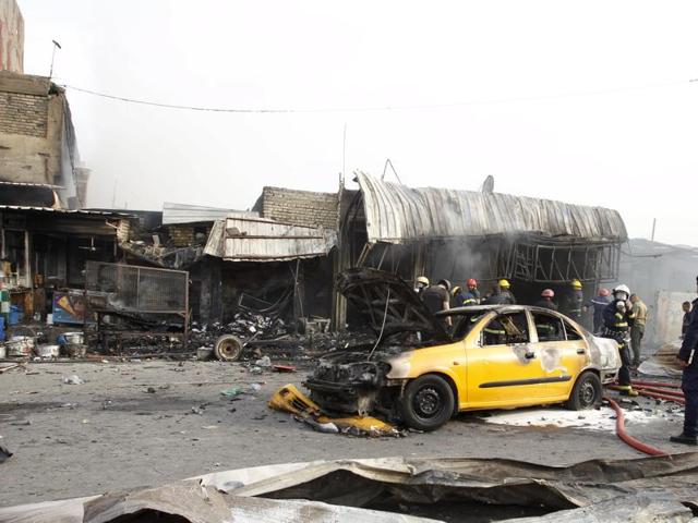People gather at the site of a car bomb attack in Baghdad al-Jadida, Iraq. (REUTERS) People gather at the site of a car bomb attack in Baghdad al-Jadida, Iraq. (REUTERS)