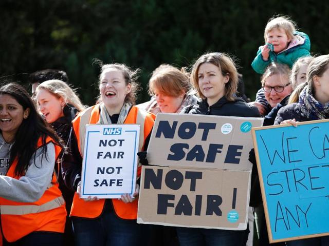 A junior doctor holds a placard during a strike outside St Thomas' Hospital in London on April 26, 2016. (REUTERS) A junior doctor holds a placard during a strike outside St Thomas' Hospital in London on April 26, 2016. (REUTERS)