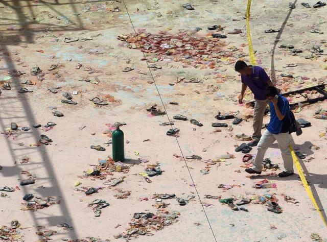 File photo from June, 2015, shows two insurance investigators checking the site of where an explosion killed 15 and injured hundreds of others at a waterpark in New Taipei City. (AFP) File photo from June, 2015, shows two insurance investigators checking the site of where an explosion killed 15 and injured hundreds of others at a waterpark in New Taipei City. (AFP)