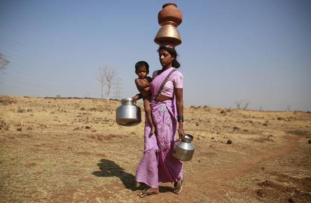 File photo of a woman along with her son walking to get water from a communal tube well at Raichi Wadi village, 120 kilometers (75 miles) north-east of Mumbai. (AP) File photo of a woman along with her son walking to get water from a communal tube well at Raichi Wadi village, 120 kilometers (75 miles) north-east of Mumbai. (AP)