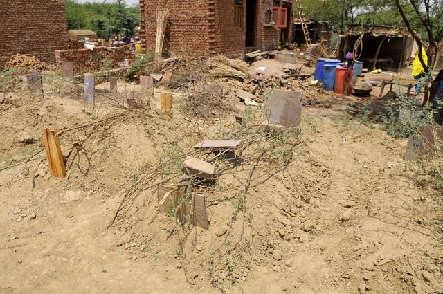 The grave of the 15-year-old girl, who was found hanging in her neighbour's house on Friday. Her body was exhumed on Saturday after her parents alleged that she was gangraped and killed by two local youths. (Abhinav Saha/HT Photo) The grave of the 15-year-old girl, who was found hanging in her neighbour's house on Friday. Her body was exhumed on Saturday after her parents alleged that she was gangraped and killed by two local youths. (Abhinav Saha/HT Photo)