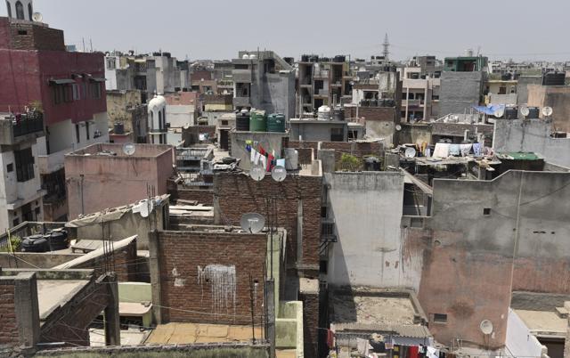 Jamia Nagar narrow lanes face major parking issues. Most of the vehicles can be seen parked along the road side. Illegal encroachments and under maintained roads have added to the congestion.(S Burmaula / HT Photo)