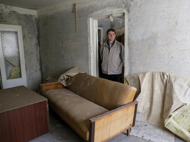 Oleksiy Yermakov, now 41, poses for a photograph in his flat in the ghost town of Pripyat, Ukraine April 5, 2016. For residents of Chernobyl, a three-day evacuation turned into a thirty-year exile. (REUTERS)