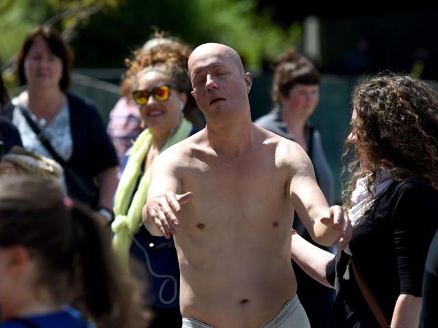 Tourists stop to look at artist Tony Matelli's Sleepwalker (2014), a lifelike figure of a man in white briefs wandering in his sleep with outstretched arms. (AFP) Tourists stop to look at artist Tony Matelli's Sleepwalker (2014), a lifelike figure of a man in white briefs wandering in his sleep with outstretched arms. (AFP)