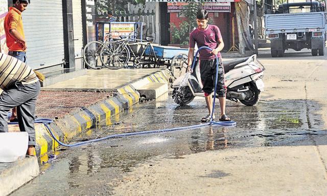 People can be seen washing their cars, watering lawns and many keep taps running. (Pardeep Pandit/HT Photo)