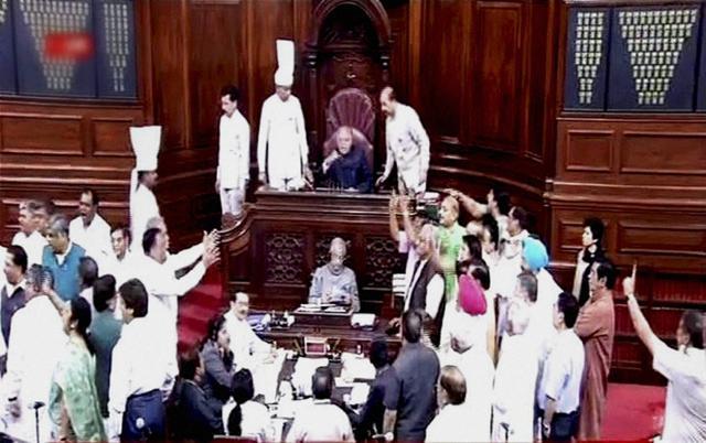 Members protest in the well of the Rajya Sabha, in New Delhi. (PTI Photo) Members protest in the well of the Rajya Sabha, in New Delhi. (PTI Photo)