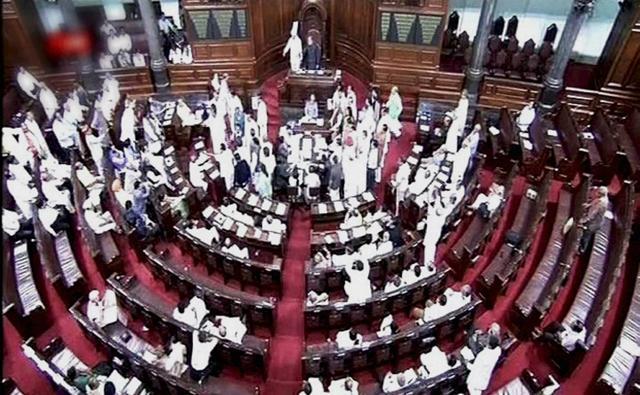 Members protest in the well of Rajya Sabha on Wednesday. (PTI) Members protest in the well of Rajya Sabha on Wednesday. (PTI)