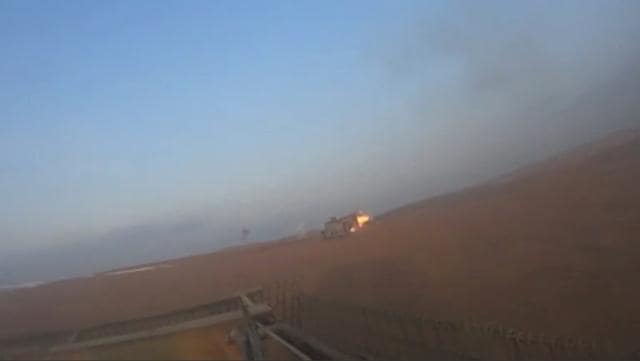 An armoured Islamic State vehicle is hit in Iraq, in this still image taken from an amateur video. (REUTERS) An armoured Islamic State vehicle is hit in Iraq, in this still image taken from an amateur video. (REUTERS)