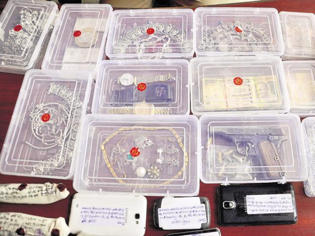 The police recovered seven mobile phones, one laptop, three Rado and Rolex watches, 2kg of gold and silver jewellery, diamond earrings and an Apache bike from the accused. (Sakib Ali/HT Photo) The police recovered seven mobile phones, one laptop, three Rado and Rolex watches, 2kg of gold and silver jewellery, diamond earrings and an Apache bike from the accused. (Sakib Ali/HT Photo)