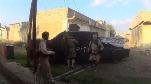 A man in an armoured vehicle, said to be a suicide bomber about to go out on a mission, talks to other Islamic State fighters in Iraq. (REUTERS) A man in an armoured vehicle, said to be a suicide bomber about to go out on a mission, talks to other Islamic State fighters in Iraq. (REUTERS)