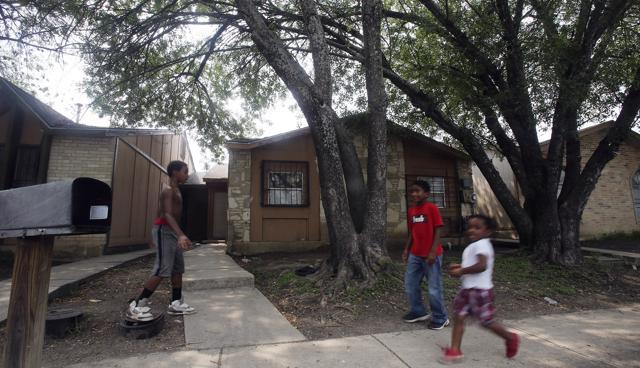 Authorities have arrested a woman who is the mother of six of eight children who were found unsupervised in the middle of the night at a San Antonio home (shown in picture) (AP)