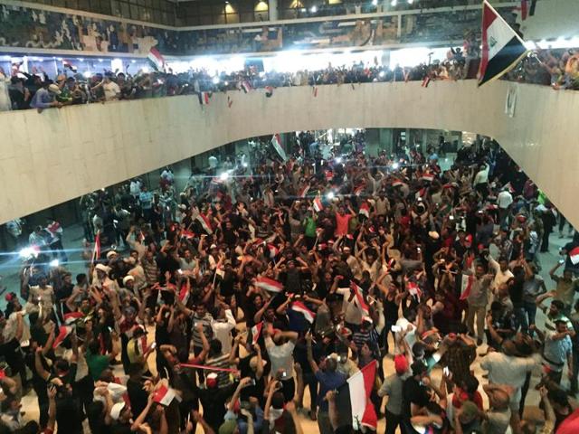 Followers of Iraq's Shia cleric Moqtada al-Sadr are seen at the parliament building as they storm Baghdad's Green Zone after lawmakers failed to convene for a vote on overhauling the government on Saturday. (Reuters) Followers of Iraq's Shia cleric Moqtada al-Sadr are seen at the parliament building as they storm Baghdad's Green Zone after lawmakers failed to convene for a vote on overhauling the government on Saturday. (Reuters)