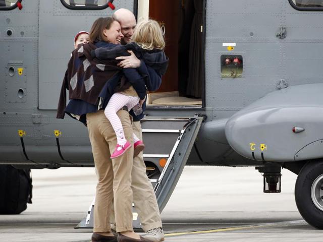 Nicolas Henin (centre) is welcomed by his family and relatives upon his arrival at the Villacoublay military airport on April 20, 2014 in Velizy-Villacoublay, France.(Getty Images)