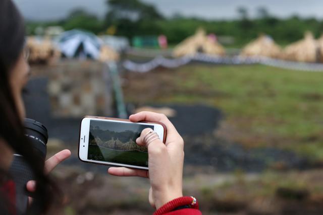 A woman takes a picture with her mobile phone of the stacks. (REUTERS)