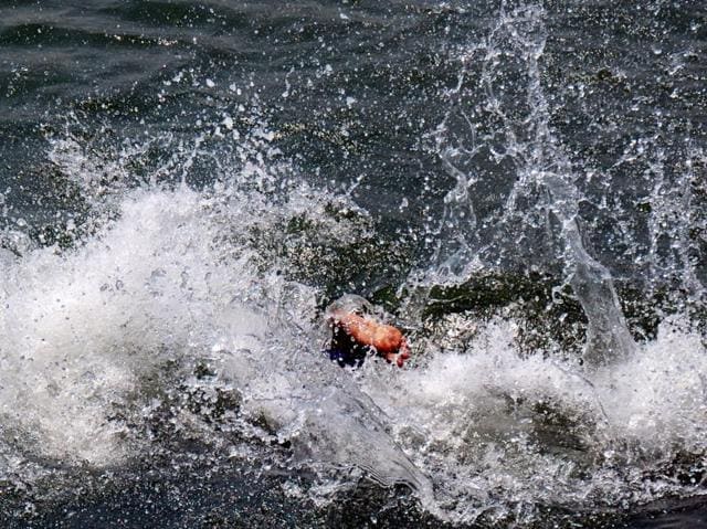 A boy beats the heat by taking a swim in the local pool. (Parwaz Khan/HT Photo) 