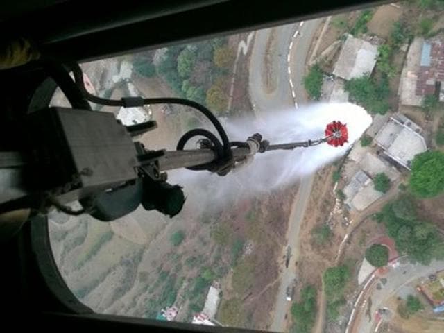 Water being sprayed on a forest in Uttarakhand from a helicopter. (PIC: PIB/Twitter) Water being sprayed on a forest in Uttarakhand from a helicopter. (PIC: PIB/Twitter)