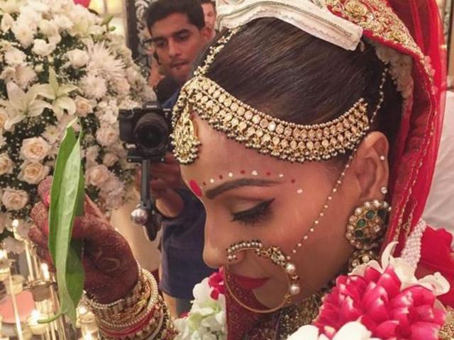 Bipasha, 37, looked radiant in her all red bridal attire which she teamed with the traditional Bengali white tiara and red-white chandan dots adorning her forehead.  (Instagram) 
