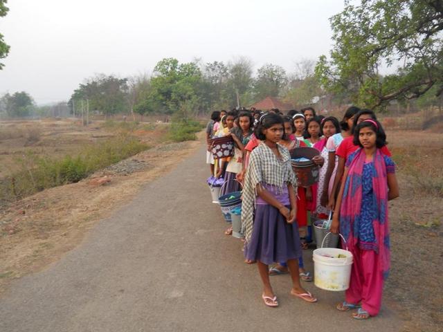 Around 250 girl students of a government run Kasturba Gandhi Residential School in Jharkhand’s Dumaria block traverse a kilometre every morning to the nearby Bheemtad river for morning ablution and bath.(HT Photo)