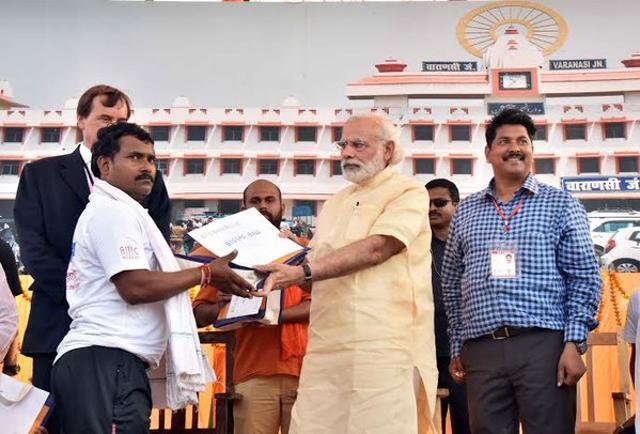 He distributed the papers of e-rickshaws to beneficiaries in Varanasi. (Photo: PIB/Twitter) He distributed the papers of e-rickshaws to beneficiaries in Varanasi. (Photo: PIB/Twitter)
