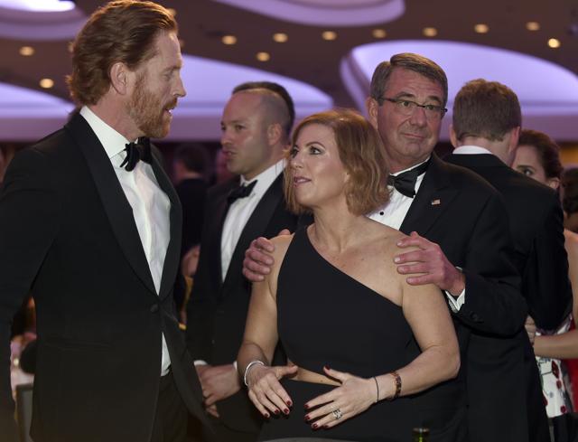 Defence secretary Ash Carter (right) holds the shoulders of his wife Stephanie (center) as she talks with "Homeland" actor Damian Lewis (left). (AP) Defence secretary Ash Carter (right) holds the shoulders of his wife Stephanie (center) as she talks with "Homeland" actor Damian Lewis (left). (AP)