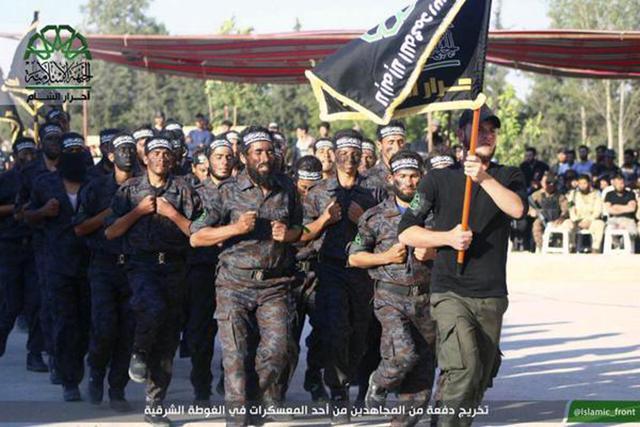 In this file image posted on the Twitter page of Ahrar al Sham on June 19, 2015, fighters march in the eastern Damascus suburb of Ghouta, Syria. (AP File Photo) In this file image posted on the Twitter page of Ahrar al Sham on June 19, 2015, fighters march in the eastern Damascus suburb of Ghouta, Syria. (AP File Photo)