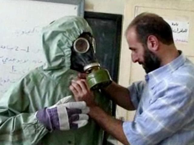 This image made from an AP video shows a volunteer adjusting a students gas mask and protective suit during a session on reacting to a chemical weapons attack in Aleppo. (AP) This image made from an AP video shows a volunteer adjusting a students gas mask and protective suit during a session on reacting to a chemical weapons attack in Aleppo. (AP)