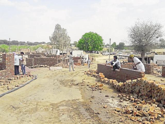 Villagers of Bhaloori in Binaker construct houses after a fire gutted their homes last month (HT Photo) Villagers of Bhaloori in Binaker construct houses after a fire gutted their homes last month (HT Photo)