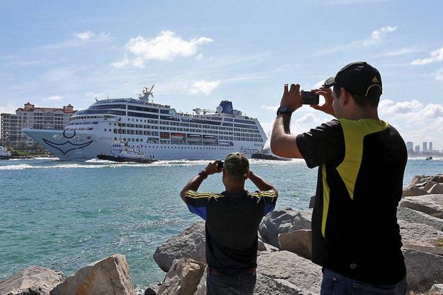 People take photos as Adonia leaves port in Miami, Sunday, May 1, 2016, en route to Cuba. (AP) People take photos as Adonia leaves port in Miami, Sunday, May 1, 2016, en route to Cuba. (AP)