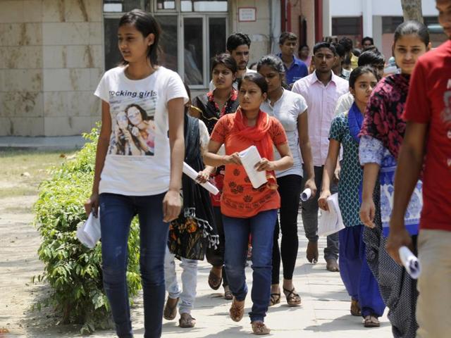 Medical aspirants coming out of the examination hall after appearing for AIPMT, in Noida on Sunday .(Sunil Ghosh / Hindustan Times)