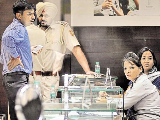 Police officials at the shop on Sunday afternoon.(Karun Sharma/HT Photo)