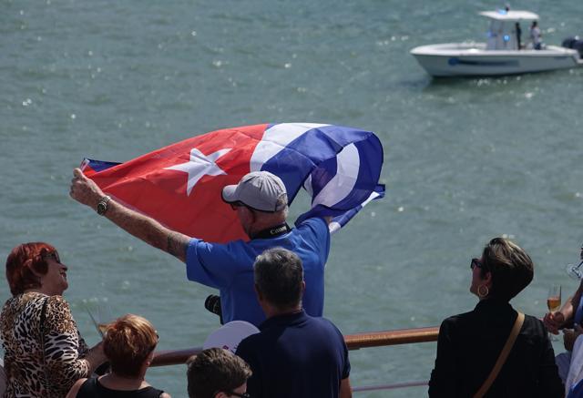 Rick Schneider of Delray Beach waves a Cuban flag onboard the Adonia as the ship leaves port in Miami, Sunday, May 1, 2016, en route to Cuba. (AP) Rick Schneider of Delray Beach waves a Cuban flag onboard the Adonia as the ship leaves port in Miami, Sunday, May 1, 2016, en route to Cuba. (AP)