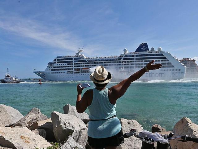 A woman from Cuba waves at Adonia las the cruise leaves the port in Miami, en route to Cuba. (AP Photo) A woman from Cuba waves at Adonia las the cruise leaves the port in Miami, en route to Cuba. (AP Photo)