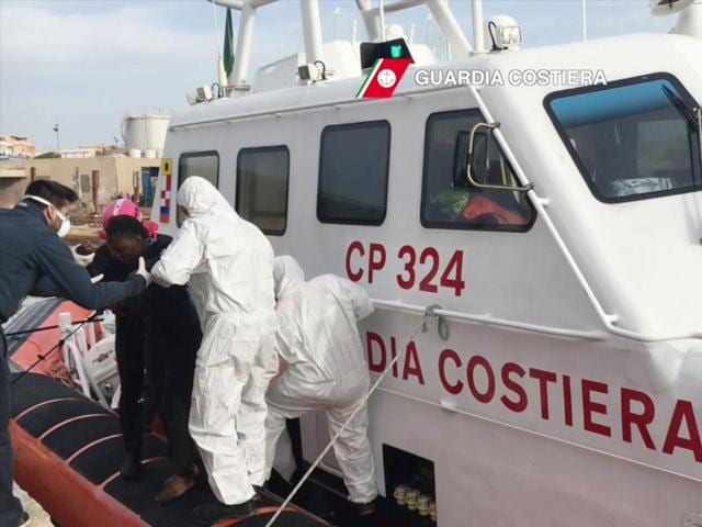 In this handout released by the Italian Coast Guards, migrants arrive at the Lampedusa harbour after a rescue operation at sea, off the coast of Libya. (AFP Photo) In this handout released by the Italian Coast Guards, migrants arrive at the Lampedusa harbour after a rescue operation at sea, off the coast of Libya. (AFP Photo)
